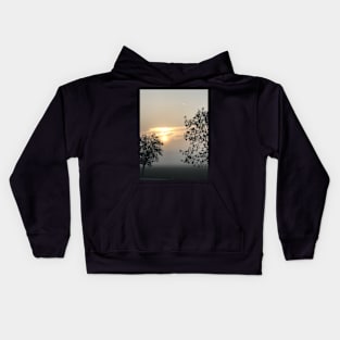 Trees in the fog during the sunset Kids Hoodie